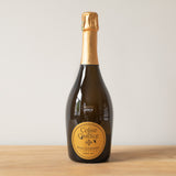 Penet-Chardonnet Coline & Candice Grand Cru 2009 Champagne bottle on a wooden table